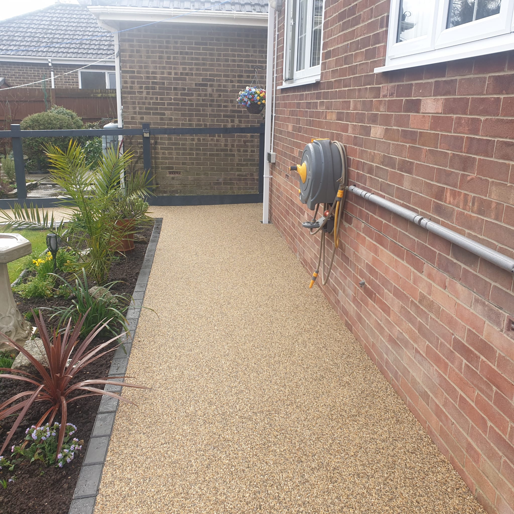 Resin bonded pathway surface installation showing textured aggregate finish